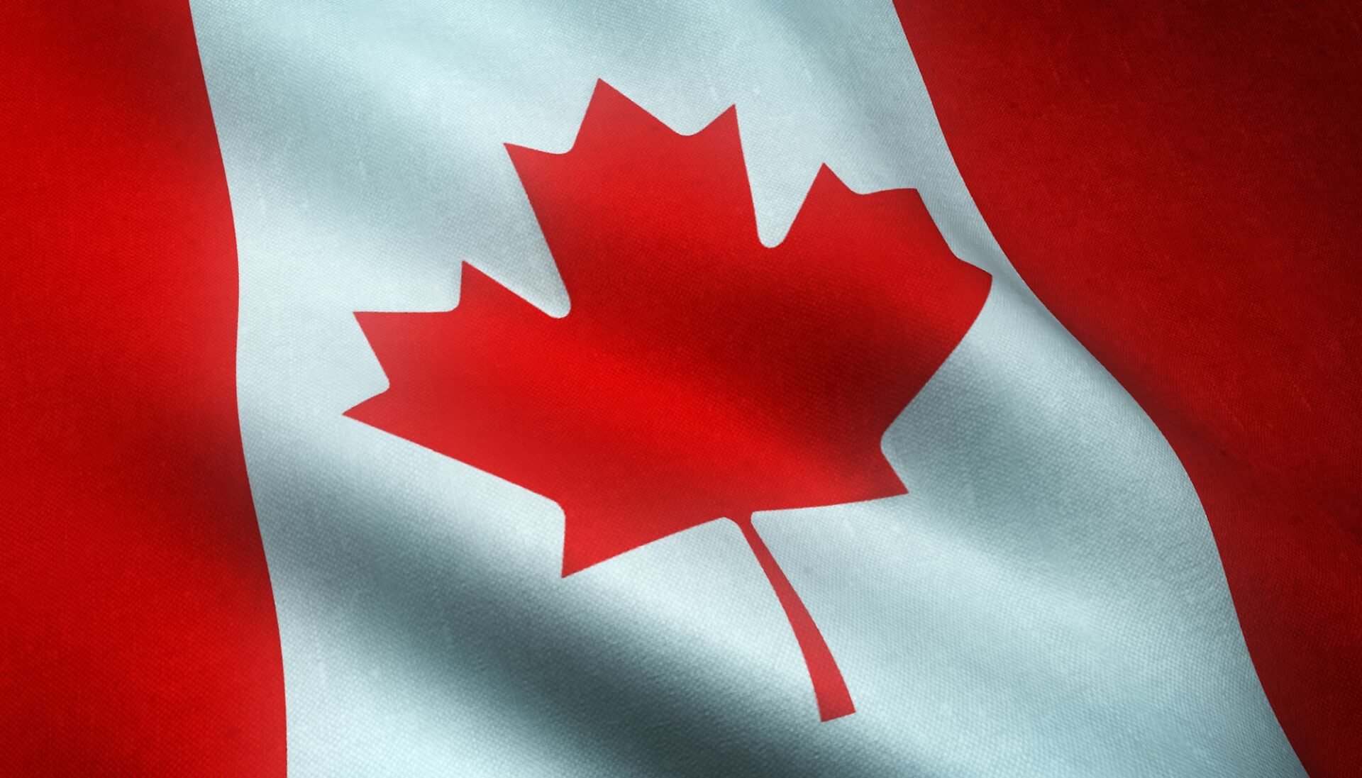 Closeup shot of the waving flag of Canada with interesting textures